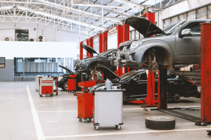 Vehicles elevated on hydraulic lifts inside full-service repair shop at Scott's Fort Collins Auto.
