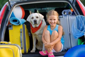 Travel, lovely girl with dog ready for family travel