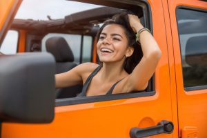 Happy woman driving a car