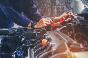 Close-up view of a professional working on a car engine.