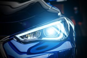 A close-up view of a headlight from a brand new car.