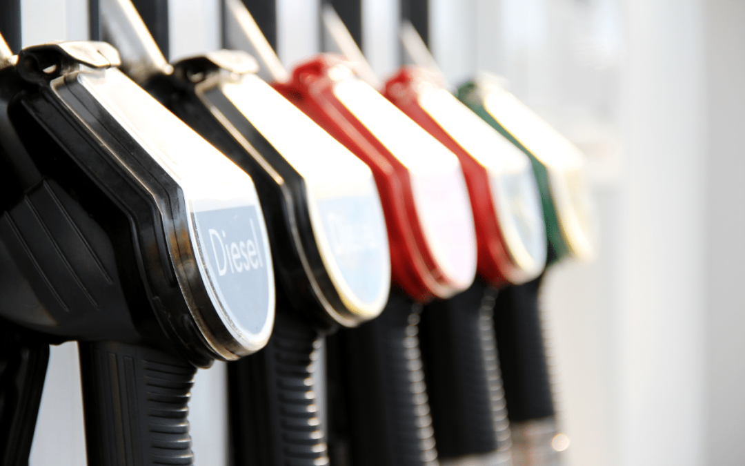 Fuel pump nozzles lined up at a gas station including diesel and gasoline options for diesel engine repair service at Scott's Fort Collins Auto.