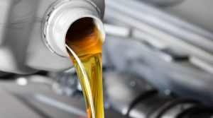 Motor oil being poured into a car. 