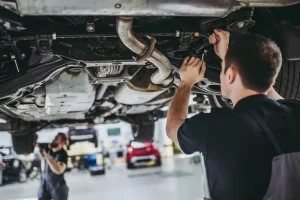 Auto technician doing regular vehicle maintenance